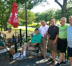 Donnie Lyons with his son and amateurs at George Wright GC