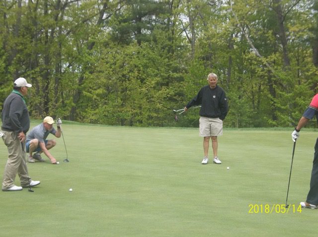 Lining up their putts John Theo, PGA with amateurs at Red Tail GC May 14, 2018